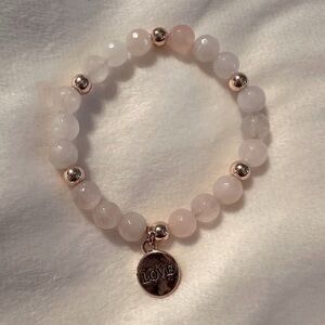Rose quartz and gold tone beaded stretch bracelet, with gold tone “Love” charm.